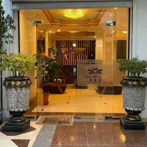a lobby with two potted plants in front of a store at Nathay Hotel in Addis Ababa Bole International Airport