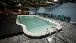 a large swimming pool with chairs around it at Quartos Beira Mar ARROIO TEIXEIRA in Capão da Canoa