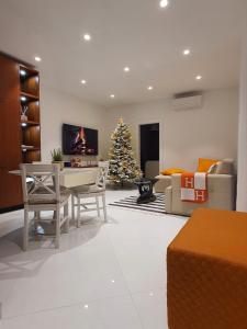 een woonkamer met een kerstboom en een bank bij NEW!!! 2024 MAREA apartments with XXL Sunny Terrace in Poreč