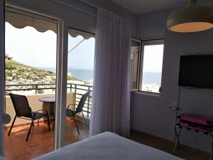 a bedroom with a bed and a view of the ocean at Panoramic View Boutique Suite in Rethymno
