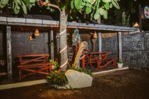 een groep tafels en banken onder een boom bij Villa Prime Time Unawatuna in Unawatuna