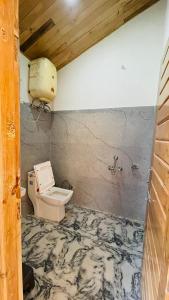 a bathroom with a sink and a toilet at The Himalayan Castle View Retreat in Nagar