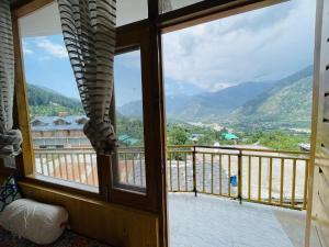 a view from a window of a balcony at The Himalayan Castle View Retreat in Nagar