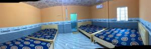 a room with two beds and a shower in it at Homestay Hải Nam Đất Mũi in Xóm Mũi