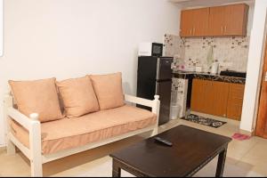 a living room with a couch and a kitchen at House Stark in Kilifi