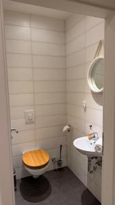 a bathroom with a wooden toilet and a sink at Mühls Apartments in Bad Lauterberg