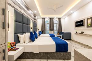 a hotel room with a large bed and a tv at Hotel MSRegency At Karol Bagh in New Delhi