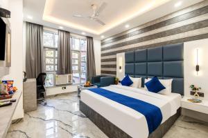 a hotel room with a bed and a desk at Hotel MSRegency At Karol Bagh in New Delhi +71 photos