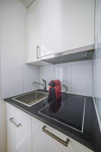 a red appliance sitting on a counter in a kitchen at Urban Hideaway Studio St Gallen Center Self Check-In in St. Gallen