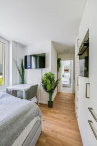 a bedroom with a bed and a desk and a table at Urban Hideaway Studio St Gallen Center Self Check-In in St. Gallen +2 photos