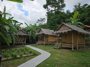 a group of huts with a path in front of them at Samui Camping Farm in Laem Sor +63 photos