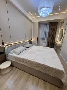 een slaapkamer met een groot bed en een blauw licht bij doma24uz in Yakkasaray