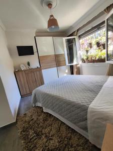 a bedroom with a bed and a window at Margarita's House 2 in Kavála