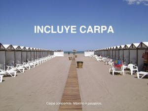 a long line of chairs on the beach at Hotel Dos Reyes in Mar del Plata