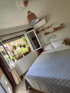 a bedroom with a bed and a large window at Margarita's House 2 in Kavála