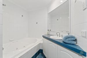 a white bathroom with a tub and a sink at Salt and Sand Escape in Lancelin +20 photos