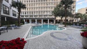 a swimming pool in front of a building at Relaxing Pool-View 1BR Near Top Houston Spots in Houston