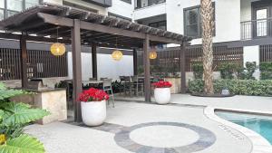 a patio with a pergola and a swimming pool at Relaxing Pool-View 1BR Near Top Houston Spots in Houston