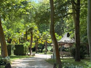 a park with a gazebo and trees at Albizias 3 in Eugénie-les-Bains