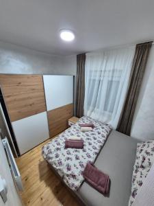 a bedroom with a bed with two pillows on it at Vilasukovo in Sukovo