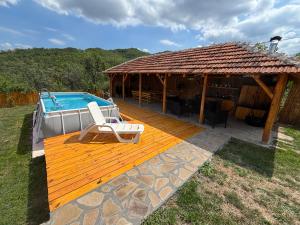 a deck with a swimming pool and a house at Vilasukovo in Sukovo