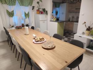 a wooden table in a kitchen with chairs around it at Holiday home Ivano in Korenica