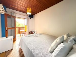 En eller flere senge i et værelse på Pousada Refugio dos Palmares