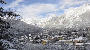 a town in the snow with mountains in the background at Bardonecchia Campo Smith 3 in Bardonecchia