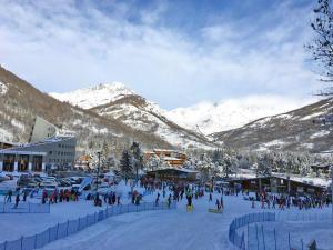 a group of people standing in the snow near a mountain at Bardonecchia Campo Smith 3 in Bardonecchia