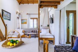 a living room with a basket of fruit on the floor at Studios Galini in Skopelos Town