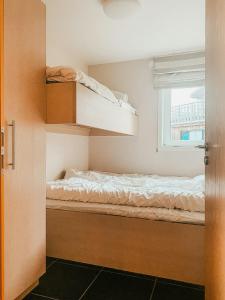 a bedroom with two bunk beds and a window at Charming Cabin Overlooking Vegglifjell in Kravikfjord