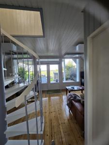 a living room with a staircase in a house at Zum Leuchtturm in Heiligenhafen