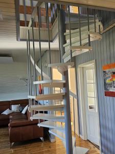 a spiral staircase in a house with a living room at Zum Leuchtturm in Heiligenhafen