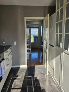 a kitchen with a door leading to a dining room at Zum Leuchtturm in Heiligenhafen +16 photos