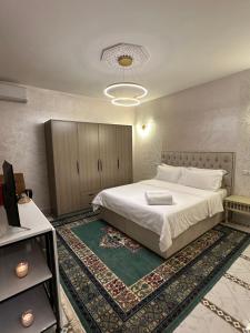 a bedroom with a large white bed with a rug at Marrakech Airport in Marrakesh