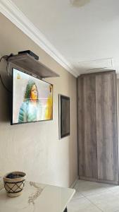 a living room with a tv on the wall at Sunrise Boutique Hotel in Witbank +79 photos