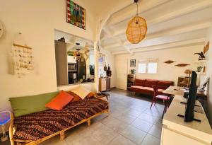 a living room with a couch and a table at Villa La Kaz a Gwada in Port-Louis