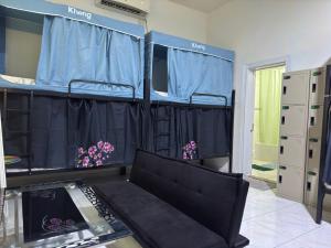 a room with two bunk beds and a couch at Bed space for Budget Backpacker - No Parking in Abu Dhabi