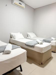a room with four beds in a room at Pousada Cidade Nova in Campo Maior