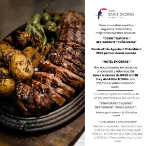 a plate of meat and vegetables on a table at Hotel Saint George in Puerto Iguazú
