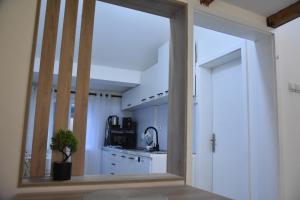 a kitchen with a large mirror in a room at Fiko Apartment in Niš +6 photos