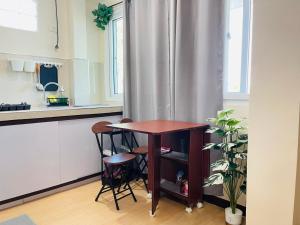 a kitchen with a table and two stools in a kitchen at Potot Haven Dorm and Transient in Libmanan
