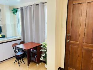 a kitchen with a table and a wooden door at Potot Haven Dorm and Transient in Libmanan +13 photos