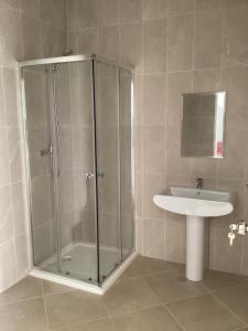 a bathroom with a shower and a sink at Fort Apartments in Vila do Porto +30 photos