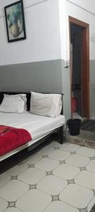 a bedroom with a bed with a red blanket and pillows at Hamala Inn Hotel in Abbottabad