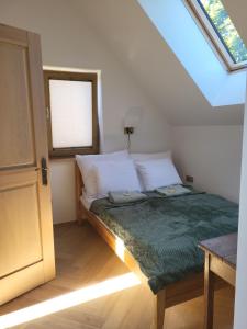 a bed in a room with a window and a bedvisor at Slow Life Rabka in Rabka-Zdrój