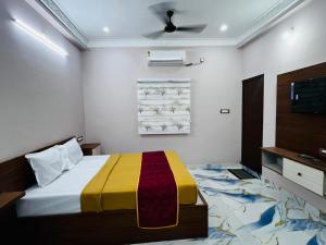 a bedroom with a bed with a colorful blanket on it at Villa D Amour in Pondicherry +14 photos