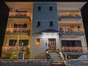 a model of a house with a christmas tree on the balcony at Alkyona apartments in Kalavrita