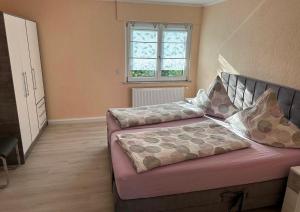 a bedroom with a bed and a window at Ferienwohnung Lena in Morbach