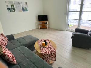 a living room with a couch and a coffee table at Ferienwohnung Lena in Morbach
